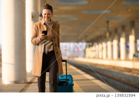 Female Traveler Navigating Train Station with Smartphone 139832894