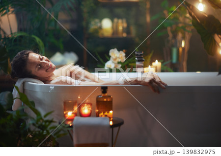 Woman Smiling in a Relaxing Bubble Bath 139832975