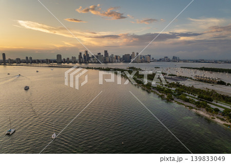 Miami, Florida. Fishing and recreational yachts and boats sailing in Biscayne Bay harbor. Sunset over city skyline with high-rise buildings in downtown Miami, Florida. Fishing and recreational yachts and boats sailing in Biscayne Bay harbor. Sunset over city skyline with high-rise buildings in downtown 139833049
