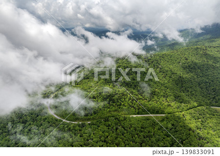 Road trip travel in Appalachian mountains. Car driving on parkway through woods nature in summer wet rainy season. Colorful forest in Tennessee Road trip travel in Appalachian mountains. Car driving on parkway through woods nature in summer wet rainy season. Colorful forest in Tennessee 139833091