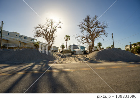 Hurricane Milton aftermath cleanup. Piles of debris and sand on street side on Manasota Key in Florida Hurricane Milton aftermath cleanup. Piles of debris and sand on street side on Manasota Key in Florida 139833096