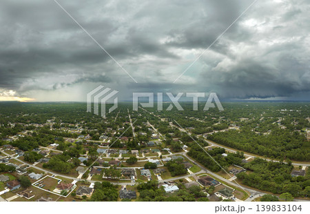 Landscape of dark ominous clouds forming on stormy sky during heavy thunderstorm over rural town area Landscape of dark ominous clouds forming on stormy sky during heavy thunderstorm over rural town area 139833104