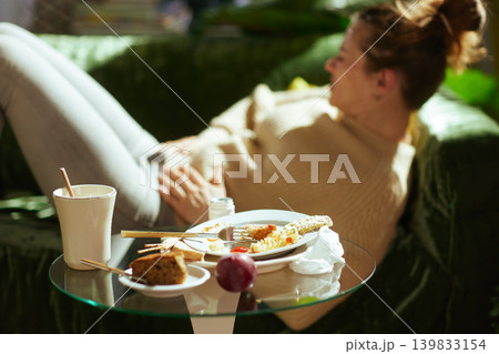 Feeling Unwell - Woman Resting on Couch After Heavy Dining 139833154