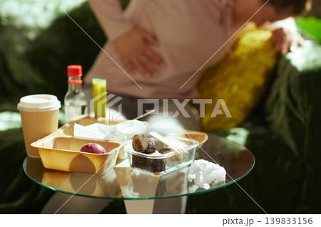 Woman Suffering from Indigestion After Fast Food Meal Woman Suffering from Indigestion After Fast Food Meal 139833156