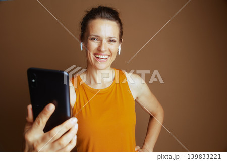 Confident Woman with Phone and Earbuds 139833221