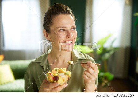 Woman Enjoying Fresh Fruit Salad at Home Woman Enjoying Fresh Fruit Salad at Home 139833257