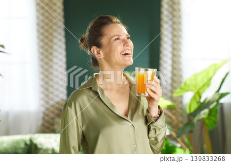 Joyful Woman Starting Her Day with Fresh Juice Joyful Woman Starting Her Day with Fresh Juice 139833268