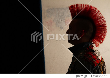 Silhouette of a young punk singer with a red mohawk hairstyle 139833332