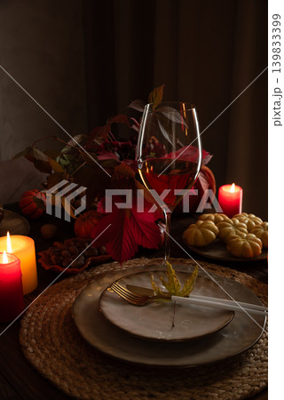 Autumn Table Setting with Plates, Wine, Pumpkins and Seasonal Decor 139833399