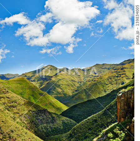 Nature, mountains and landscape background for green tourism, earth and eco friendly environment. Aerial view of the countryside and hill to explore, adventure or environment on a cloudy and blue sky Nature, mountains and landscape background for green tourism, earth and eco friendly environment. Aerial view of the countryside and hill to explore, adventure or environment on a cloudy and blue sky 139834005