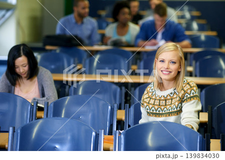 University, students and portrait in lecture, class and learning in hall for education. College, campus and people studying for course in school and writing notes for project, research or knowledge University, students and portrait in lecture, class and learning in hall for education. College, campus and people studying for course in school and writing notes for project, research or knowledge 139834030