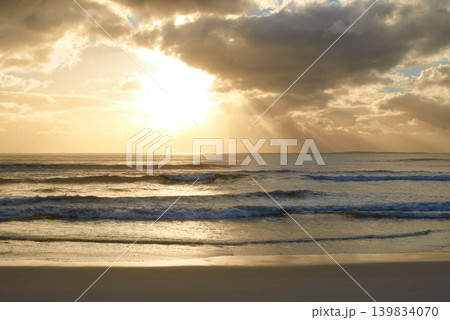 Sunset, beach or ocean water with clouds in summer, vacation or sunshine at background of horizon. Sea, waves or sand on land at twilight outdoor in nature, seashore or coastline to travel on holiday Sunset, beach or ocean water with clouds in summer, vacation or sunshine at background of horizon. Sea, waves or sand on land at twilight outdoor in nature, seashore or coastline to travel on holiday 139834070