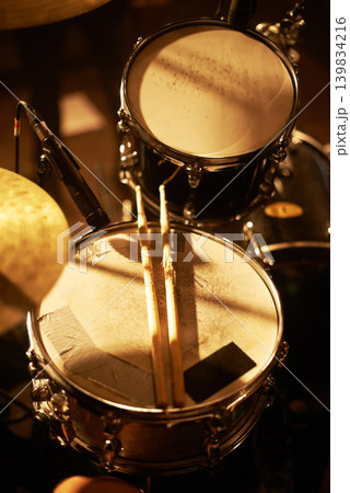 Drum, microphone and music in closeup for studio, record and rehearsal for stage, performance and studio with passion. Instrument, equipment and musician with entertainment for live at concert Drum, microphone and music in closeup for studio, record and rehearsal for stage, performance and studio with passion. Instrument, equipment and musician with entertainment for live at concert 139834216