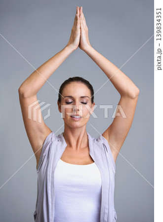 Woman, meditation and namaste in zen, spiritual wellness or inner peace on a gray studio background. Calm, young female person or yogi with hands together for peaceful meditating, health or awareness 139834351