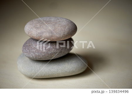 Stack, studio or stones at spa for healing, massage or wellness treatment therapy for balance. Pile, aromatherapy and rocks for a calm, zen or peace atmosphere at a natural salon on grey background Stack, studio or stones at spa for healing, massage or wellness treatment therapy for balance. Pile, aromatherapy and rocks for a calm, zen or peace atmosphere at a natural salon on grey background 139834496