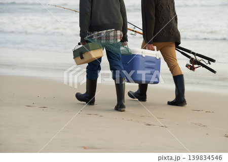 Walk, fishing and men on beach together with cooler, tackle box and holiday adventure. Ocean, fisherman and friends with rods, bait and tools for hobby at waves on winter morning vacation at sea. Walk, fishing and men on beach together with cooler, tackle box and holiday adventure. Ocean, fisherman and friends with rods, bait and tools for hobby at waves on winter morning vacation at sea. 139834546