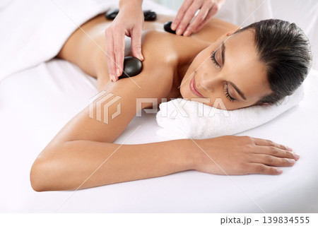 Hot stone, woman and hands massage shoulder for skincare, beauty and pamper body for wellness at luxury salon. Back, rocks and happy person at spa for treatment, relax or health with masseuse Hot stone, woman and hands massage shoulder for skincare, beauty and pamper body for wellness at luxury salon. Back, rocks and happy person at spa for treatment, relax or health with masseuse 139834555