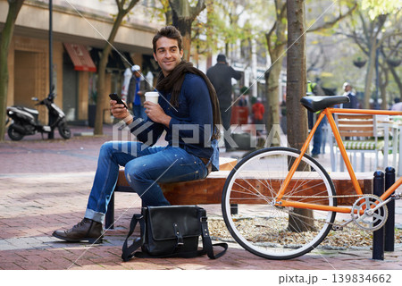 Man, smartphone and coffee and bike for travel and carbon footprint, communication and cycling outdoor. Eco friendly transport, using phone for location in city for journey with bicycle and drink 139834662