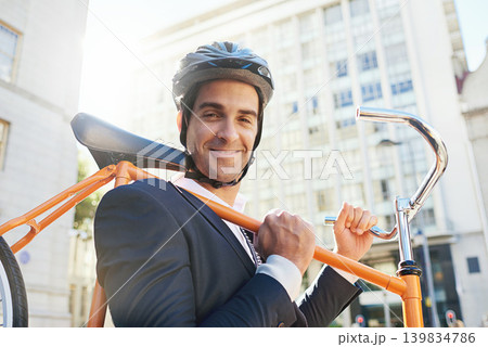 Morning, bicycle and city with portrait of businessman with commute for green and sustainable transport. Cyclist, smile and bike for carbon footprint in New York by urban street with cycling to job Morning, bicycle and city with portrait of businessman with commute for green and sustainable transport. Cyclist, smile and bike for carbon footprint in New York by urban street with cycling to job 139834786