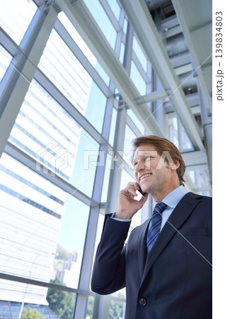 Phone call, walking in office and business man in discussion, talking and conversation in lobby. Corporate worker, professional and person on cellphone for networking, contact and communication Phone call, walking in office and business man in discussion, talking and conversation in lobby. Corporate worker, professional and person on cellphone for networking, contact and communication 139834803