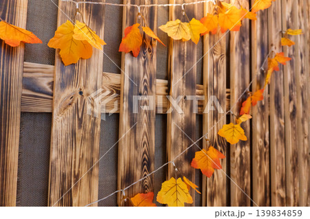 Autumn Leaves Garland on Wooden Fence Autumn Leaves Garland on Wooden Fence 139834859