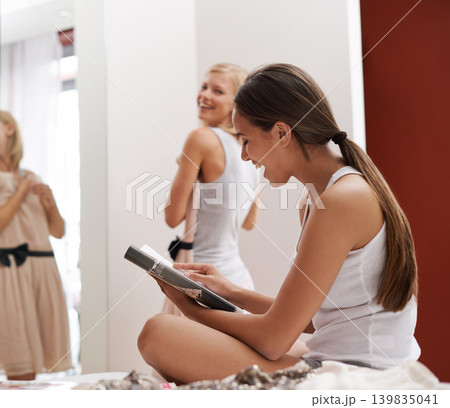 Women, friends and dress in bedroom, laugh and mirror at home for style and beauty. Female, smile and fashion to show, wear and impress for agency or excited for appointment classy event or date Women, friends and dress in bedroom, laugh and mirror at home for style and beauty. Female, smile and fashion to show, wear and impress for agency or excited for appointment classy event or date 139835041