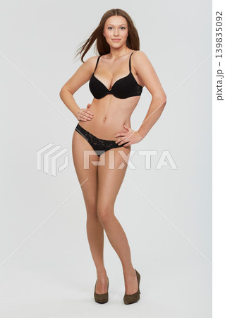 Body, beauty and portrait of woman with lingerie in studio for wellness, glowing skin or care on white background. Underwear, shape and female model with confidence, smile or classy style choice Body, beauty and portrait of woman with lingerie in studio for wellness, glowing skin or care on white background. Underwear, shape and female model with confidence, smile or classy style choice 139835092