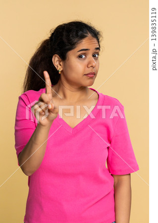 Indian woman shaking finger and head disapprovingly, showing clear no warning to camera Indian woman shaking finger and head disapprovingly, showing clear no warning to camera 139835119