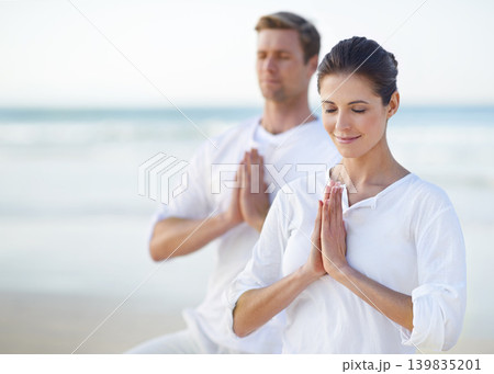 Couple, yoga and ocean with meditation, peace and sitting on sand in morning with mindfulness in summer. Man, woman and outdoor for namaste with spiritual growth, balance or zen at beach in Cape Town Couple, yoga and ocean with meditation, peace and sitting on sand in morning with mindfulness in summer. Man, woman and outdoor for namaste with spiritual growth, balance or zen at beach in Cape Town 139835201
