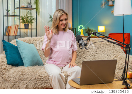 Pregnant woman hosting live webinar laptop studio mic giving prenatal guidance teaching moms support Pregnant woman hosting live webinar laptop studio mic giving prenatal guidance teaching moms support 139835436