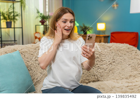 Pregnant woman exclaims wow at huge baby clothes sale discount seen on smartphone amazed by savings Pregnant woman exclaims wow at huge baby clothes sale discount seen on smartphone amazed by savings 139835492