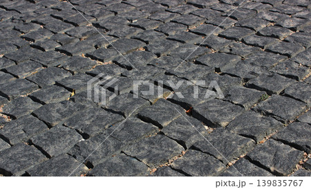 An angled view of evenly laid rows of dark granite paving stones An angled view of evenly laid rows of dark granite paving stones 139835767