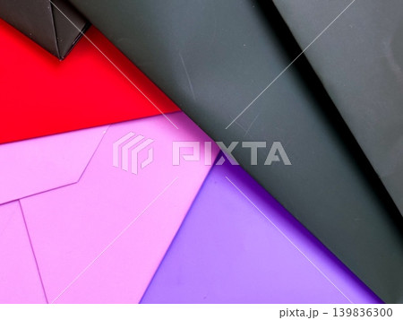 Different sheets of paper on flat surface, red, pink, purple and black colors. Decorative background for design. Various angles, creating layered effect. Textures and colors of paper Different sheets of paper on flat surface, red, pink, purple and black colors. Decorative background for design. Various angles, creating layered effect. Textures and colors of paper 139836300