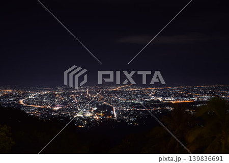 Wide night cityscape glowing urban lights viewed from mountain overlooking roads neighborhoods illuminated skyline Wide night cityscape glowing urban lights viewed from mountain overlooking roads neighborhoods illuminated skyline 139836691
