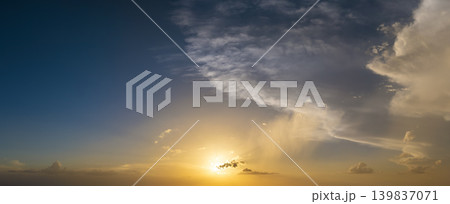 Beautiful sunset sky scenery. Bright colorful orange and yellow clouds on horizon 139837071
