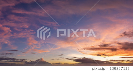 Sunset sky with bright colorful orange and yellow clouds. Panoramic skyscape Sunset sky with bright colorful orange and yellow clouds. Panoramic skyscape 139837135