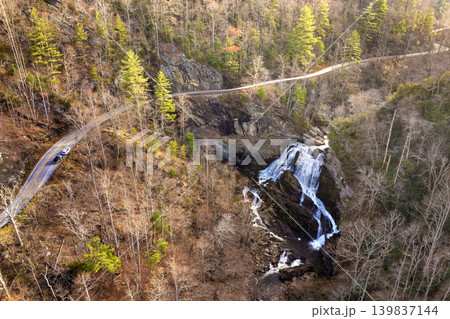 Scenic drive near Cullasaja Falls in the Nantahala National Forest. Highlands Road curves through rocky terrain and fall woods. Scenic drive near Cullasaja Falls in the Nantahala National Forest. Highlands Road curves through rocky terrain and fall woods. 139837144