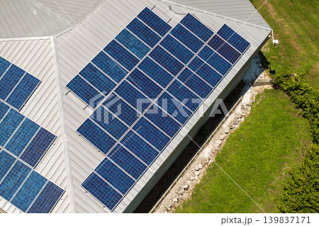 Residential house with rooftop covered with solar photovoltaic panels for producing of clean ecological electrical energy in suburban rural area. Concept of autonomous home 139837171