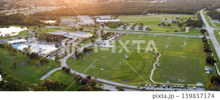 Public sports stadium with school kids playing football game at sunset. Active way of life concept 139837174