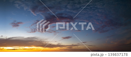 Dramatic sunset sky covered with colorful yellow clouds. Panoramic skyscape Dramatic sunset sky covered with colorful yellow clouds. Panoramic skyscape 139837178