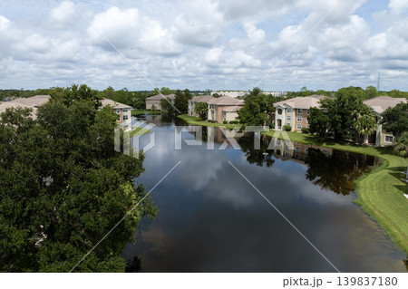 Aerial view of American apartment buildings in Florida residential area. New family condos as example of housing development in US suburbs Aerial view of American apartment buildings in Florida residential area. New family condos as example of housing development in US suburbs 139837180
