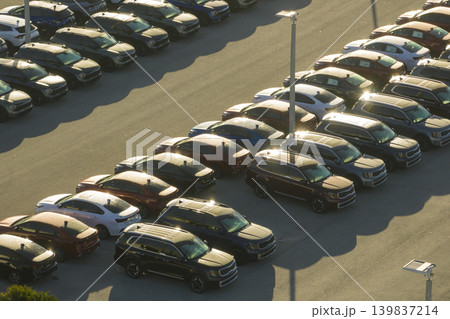 Large parking lot of local dealer with many brand new cars parked for sale. Development of american automotive industry and distribution of manufactured vehicles concept Large parking lot of local dealer with many brand new cars parked for sale. Development of american automotive industry and distribution of manufactured vehicles concept 139837214