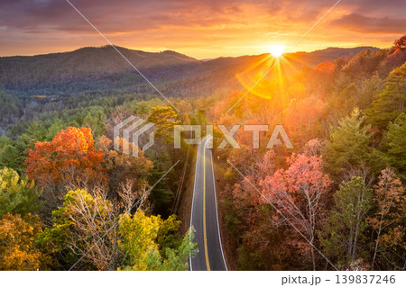 Car driving along mountain road surrounded by colorful autumn trees in Tennessee. Scenic road trip through the Appalachians in fall season Car driving along mountain road surrounded by colorful autumn trees in Tennessee. Scenic road trip through the Appalachians in fall season 139837246