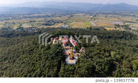 Aerial view of Wat Phra That Chom Wae temple located in Phan district of Chiang Rai province of Thailand. This place is one of the 9 important pagodas of Chiang Rai province, Thailand. Aerial view of Wat Phra That Chom Wae temple located in Phan district of Chiang Rai province of Thailand. This place is one of the 9 important pagodas of Chiang Rai province, Thailand. 139837776