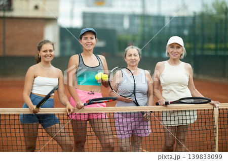 Group of women posing on tennis court Group of women posing on tennis court 139838099