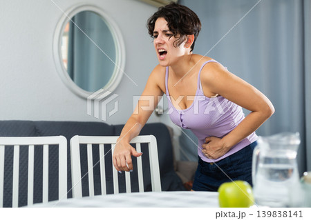 Young female having painful stomachache Young female having painful stomachache 139838141