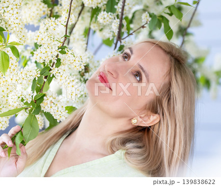 Portrait of a woman with natural beauty at the blooming tree in spring. 139838622
