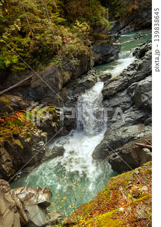 Waterfall in the autumn canyon among moss and ferns in the rainforest. Waterfall in the autumn canyon among moss and ferns in the rainforest. 139838645