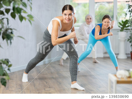 Positive women engaged in active dancing Positive women engaged in active dancing 139838690