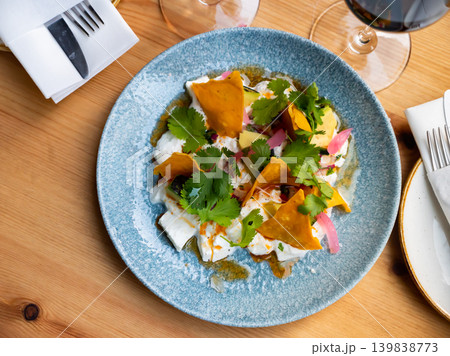 Salad with burrata cheese, avocado, greens and tortilla chips Salad with burrata cheese, avocado, greens and tortilla chips 139838773